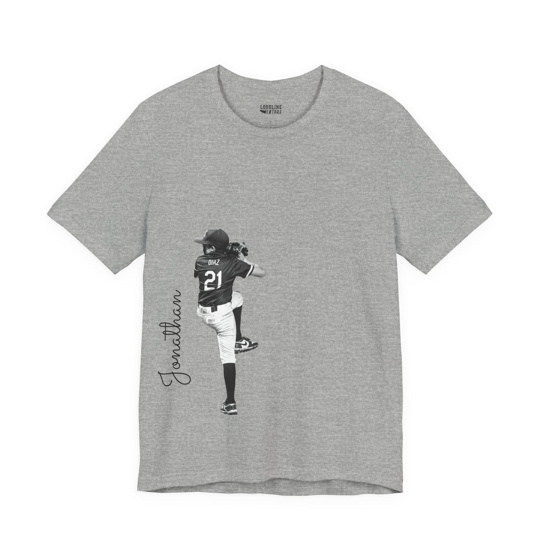 Gray t-shirt with a graphic of a person in a sports uniform and the name &