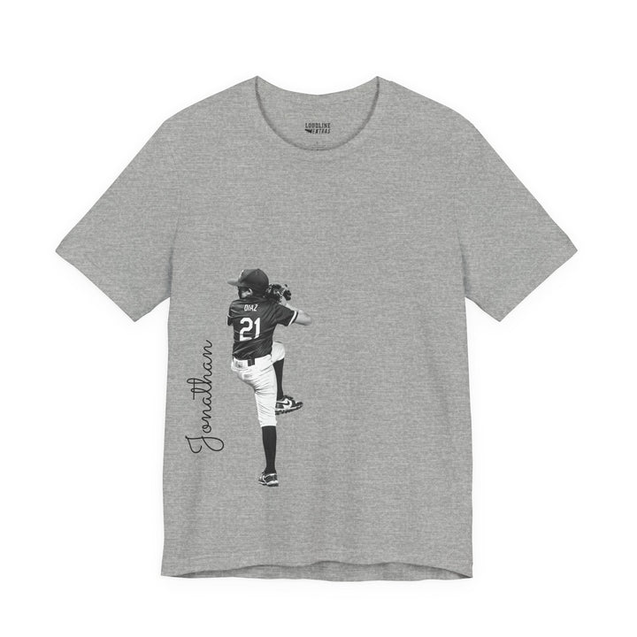 Gray t-shirt with a graphic of a person in a sports uniform and the name &