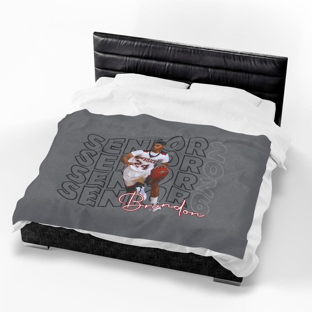 Gray comforter with a printed design on a bed
