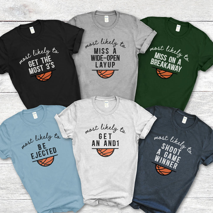 Collection of six basketball-themed t-shirts with humorous sayings on a wooden surface.