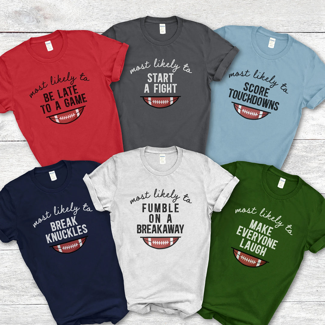 Collection of football-themed t-shirts with humorous sayings on a wooden surface.