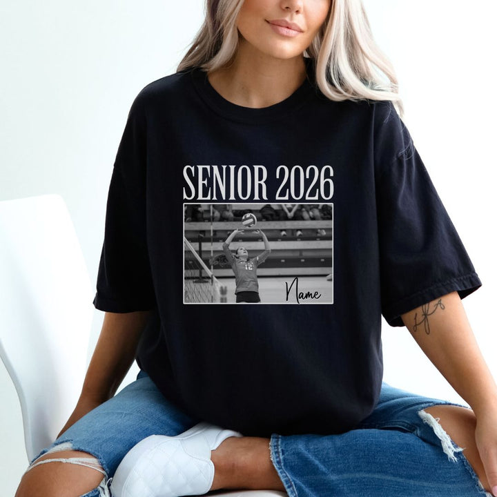 Person wearing a black t-shirt with &